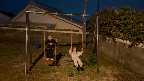 그네를 타며 미디어파사드 전시를 보는 심하윤, 심지윤